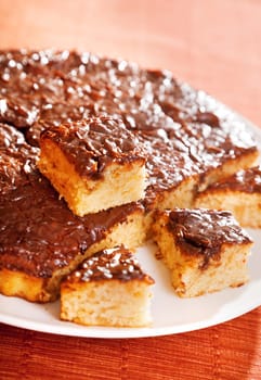 Homemade cake with chocolate glaze cut into pieces