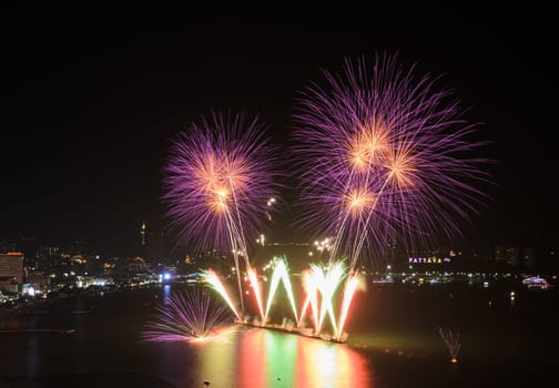 Beautiful pink firework at Pattaya coast with cityscape background, Thailand