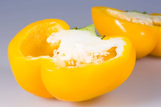 Sliced Yellow Bell Pepper close up on grey background.