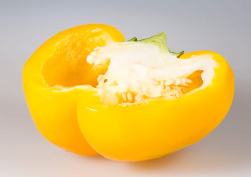 Sliced Yellow Bell Pepper close up on grey background.