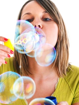 Girl blowing bubbles, isolated on white