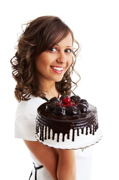 Young woman eating cherry from a chocolate cake, isolated on white
