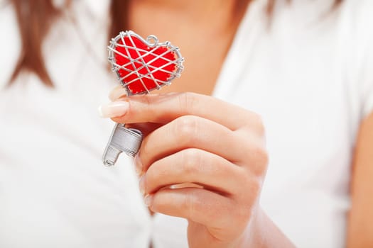 Woman holding heartshaped key in her hand, close up