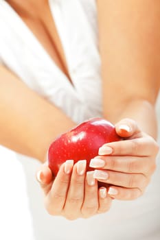 Young woman holding red apple in her hands, isolated on white