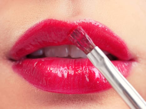 Attractive woman lips with red lipstick, close up