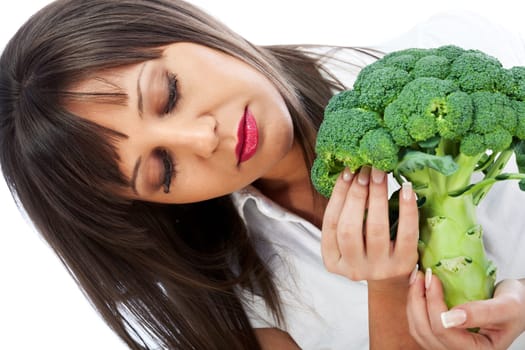 Young woman holding broccoli isolated on white