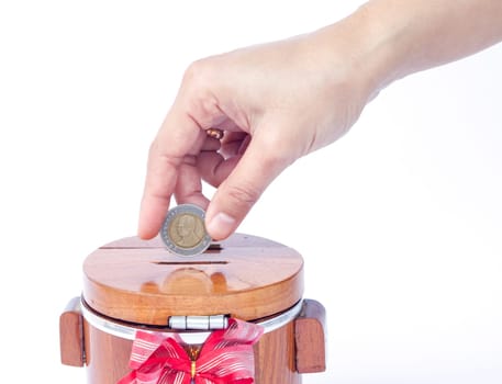 Putting coin to save money, stock photo