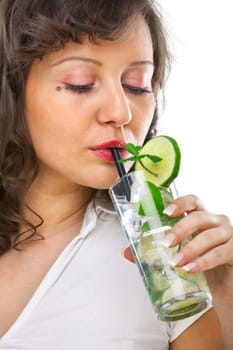 Young woman drinking mojito on white background