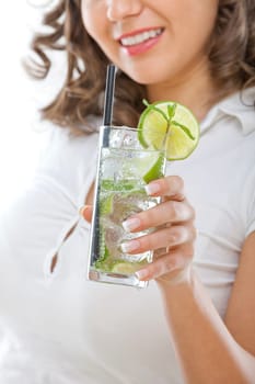 Young woman drinking mojito on white background