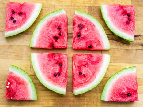 Watermelon slice arranged on a wooden board, raw food fruit stilllife with copyspace