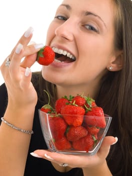 Young woman eating strawberries