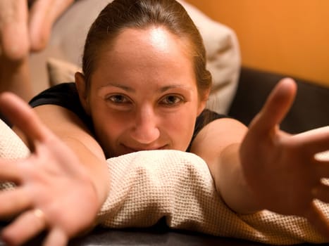 Woman with open arms in bed