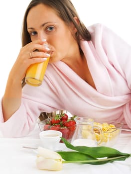 Woman having breakfast in bed, isolated on white