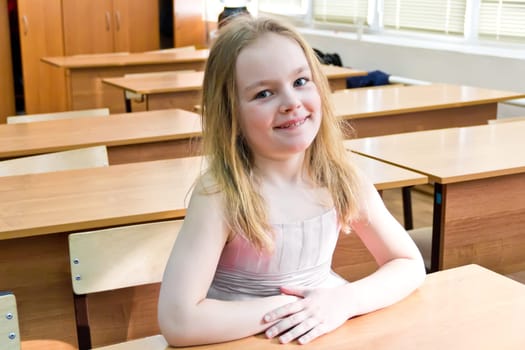 Portrait of cute younger schoolgirl with blond hair
