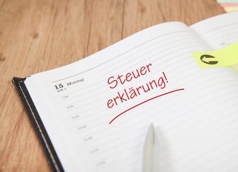 an open calendar with post it and the text tax return