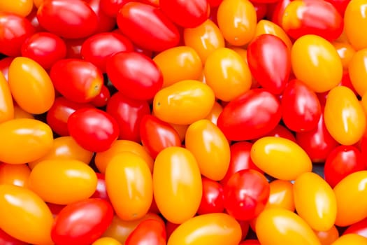 Photo of background with fresh red and yellow tomatos