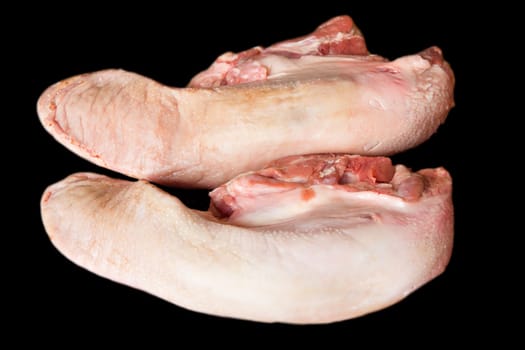 Photo of raw pork tongue on black background