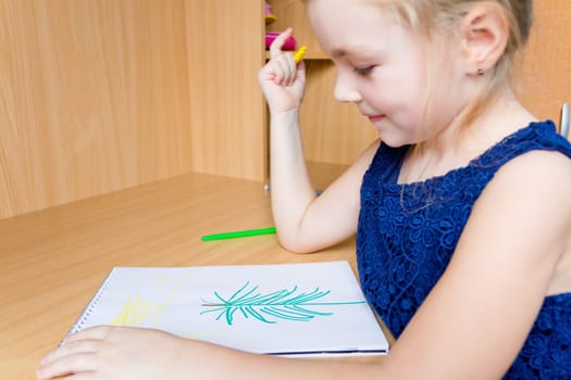Photo of cute drawing girl with blond hair