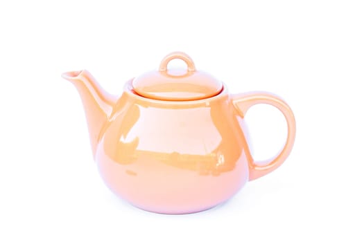 Orange ceramic teapot isolated on white background, stock photo