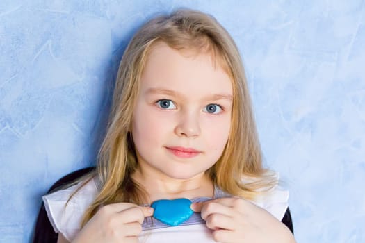 Portrait of cute girl with blue heart