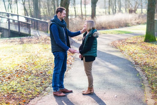 young pregnant woman with her husband in the park