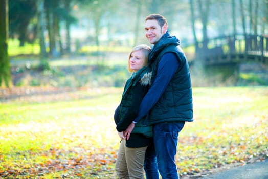 young pregnant woman with her husband in the park