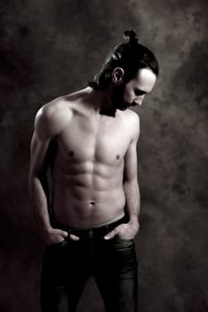 young white man exercised body in front of gray background