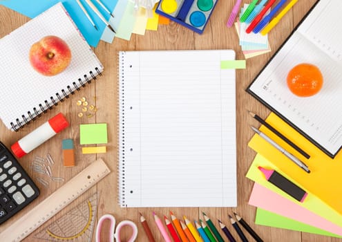 a writing booklet on a desk with pens and accessories to draw