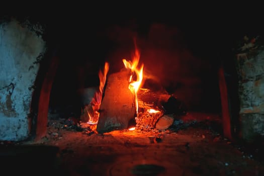 Firewood burn in the stove. Rural background with fire flames.