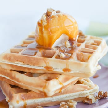 Waffles with vanilla ice cream ,caramel and walnuts