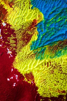 format-filling view of a surface dotted with colorful pasty colors