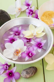 Fresh colorful orchids swimming in Schuessel with water
