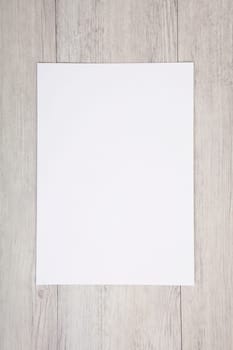 a white sheet of paper without text lies on a bright background