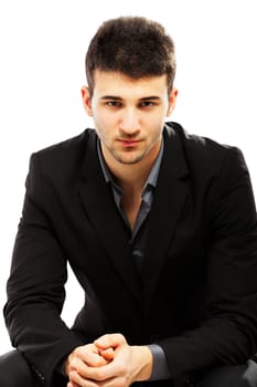 Young businessman portrait isolated on white. Sitting on a chair
