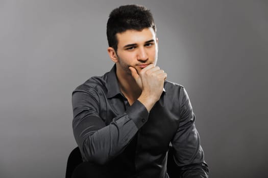 Young businessman portrait isolated on gray background