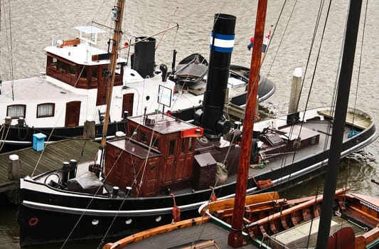 Old boats at the bank of Amsterdam docks
