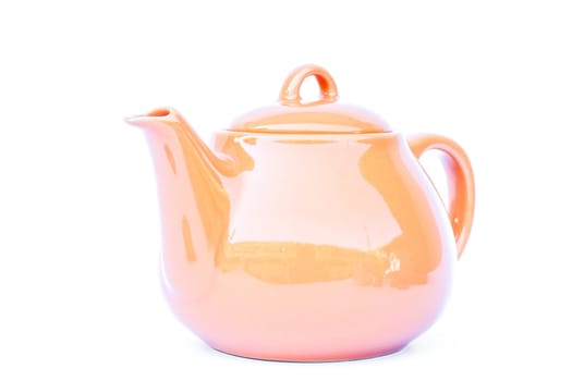 Orange ceramic teapot isolated on white background, stock photo