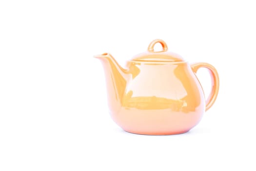 Orange ceramic teapot isolated on white background, stock photo