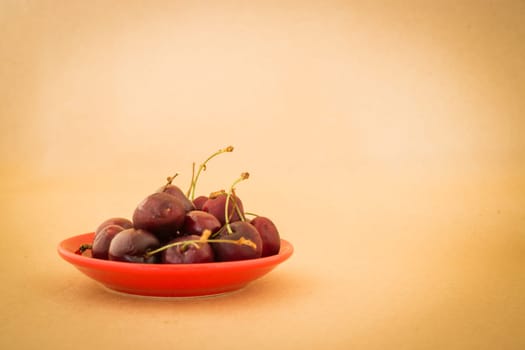 Group of cherries on warm vintage background, stock photo