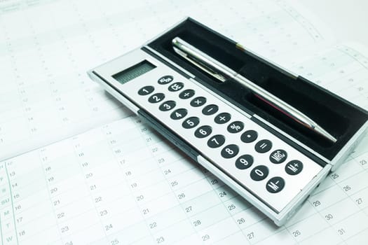 Pocket calculator and pen on the table, stock photo