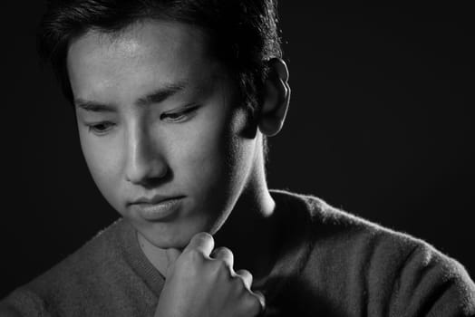 A headshot of a young handsome Japanese man.