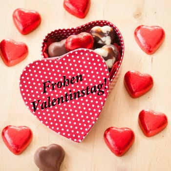 Chocolate box with hearts of chocolate in red