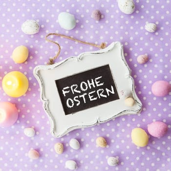 Vintage table with colorful Easter eggs on dotted background