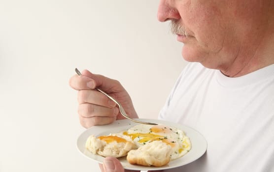 A man ready to eat his fried eggs breakfast