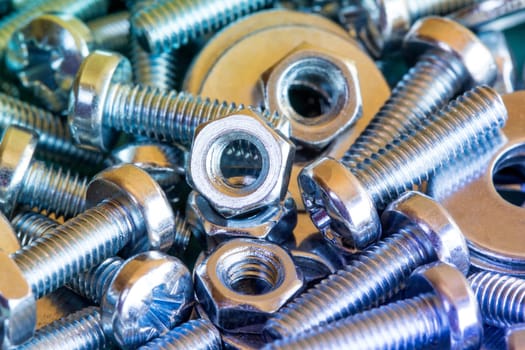 Chrome bolts and nuts close-up with colorful tone