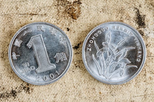 One yuan 2011 coin chinese money,  on a old canvas background