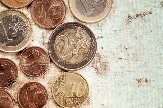 Euro coins currency on canvas background with copy-space.Vintage tone and grain.
