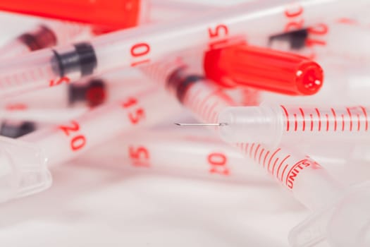 Small syringes with hypodermic needles and protective caps Drugs diabetes as a close-up