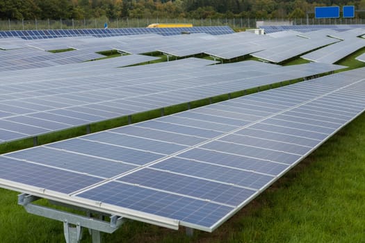 Solar cells in a solar park on green meadow for electricity generation