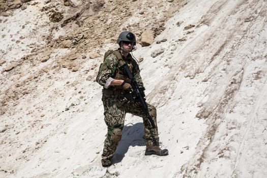 Member of Navy SEAL Team with weapons in action